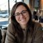 A woman in her 30s with brown hair and glasses, friendly and approachable (1) (1)
